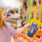 Child holding a yellow craft kit package in a store setting
Child choosing a paper crafting kit in a store aisle, highlighting gift suitability.